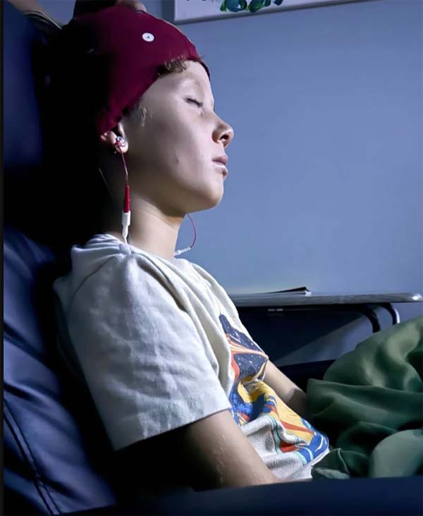 Girl Practicing a Neurofeedback Therapy Session With Closed Eyes